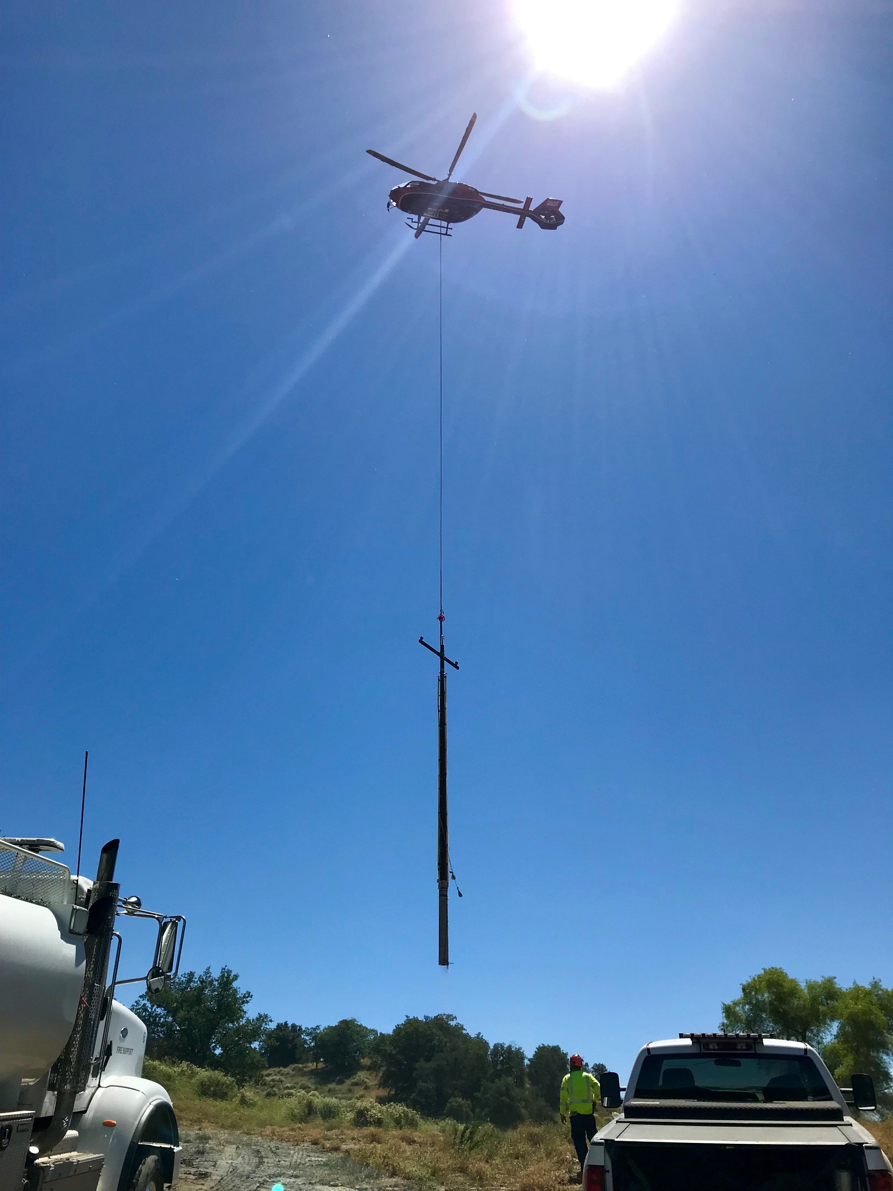 Helicopter setting a power pole
