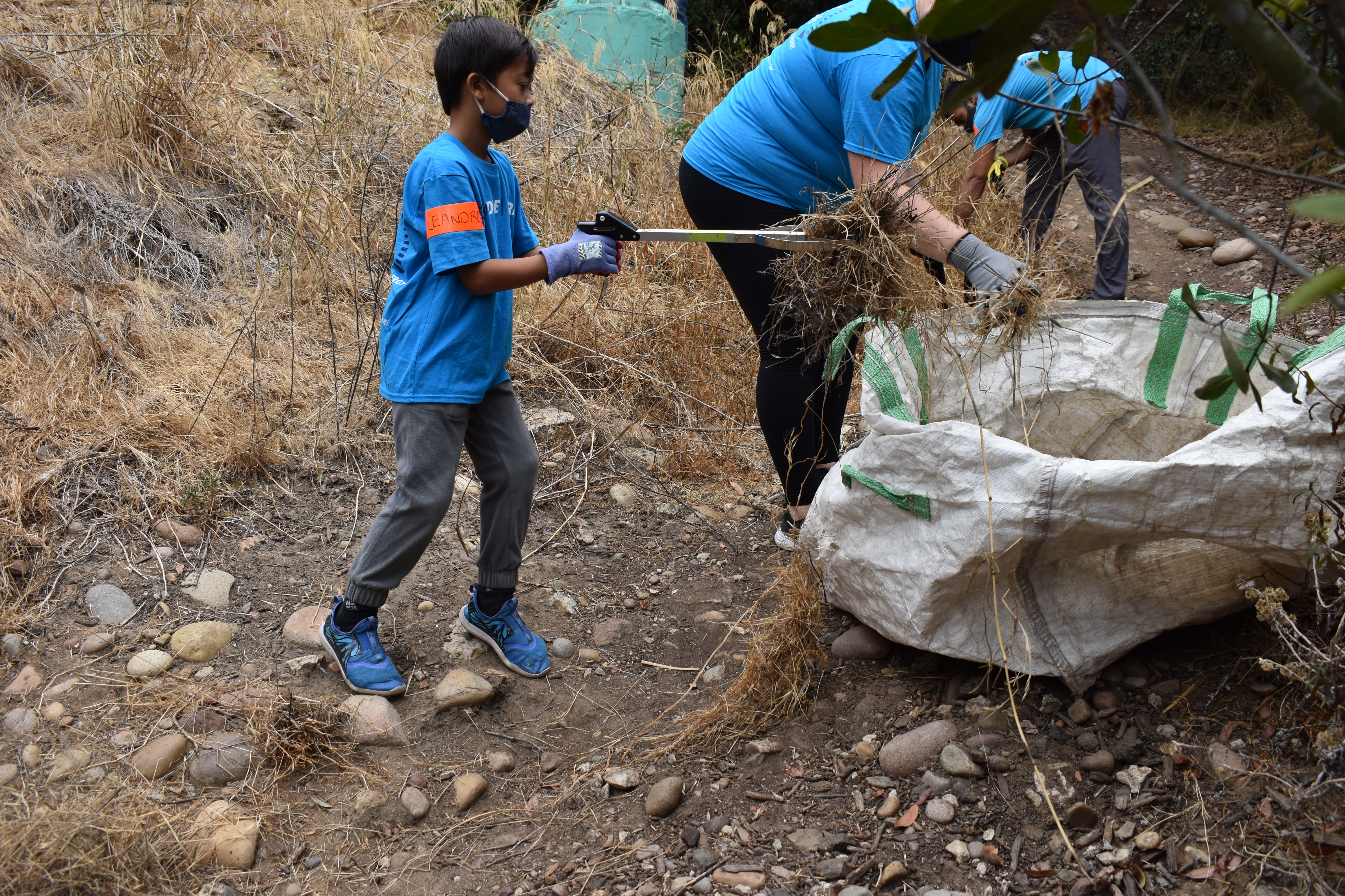 Volunteers work to clean up Manzanita Canyon in City Heights.