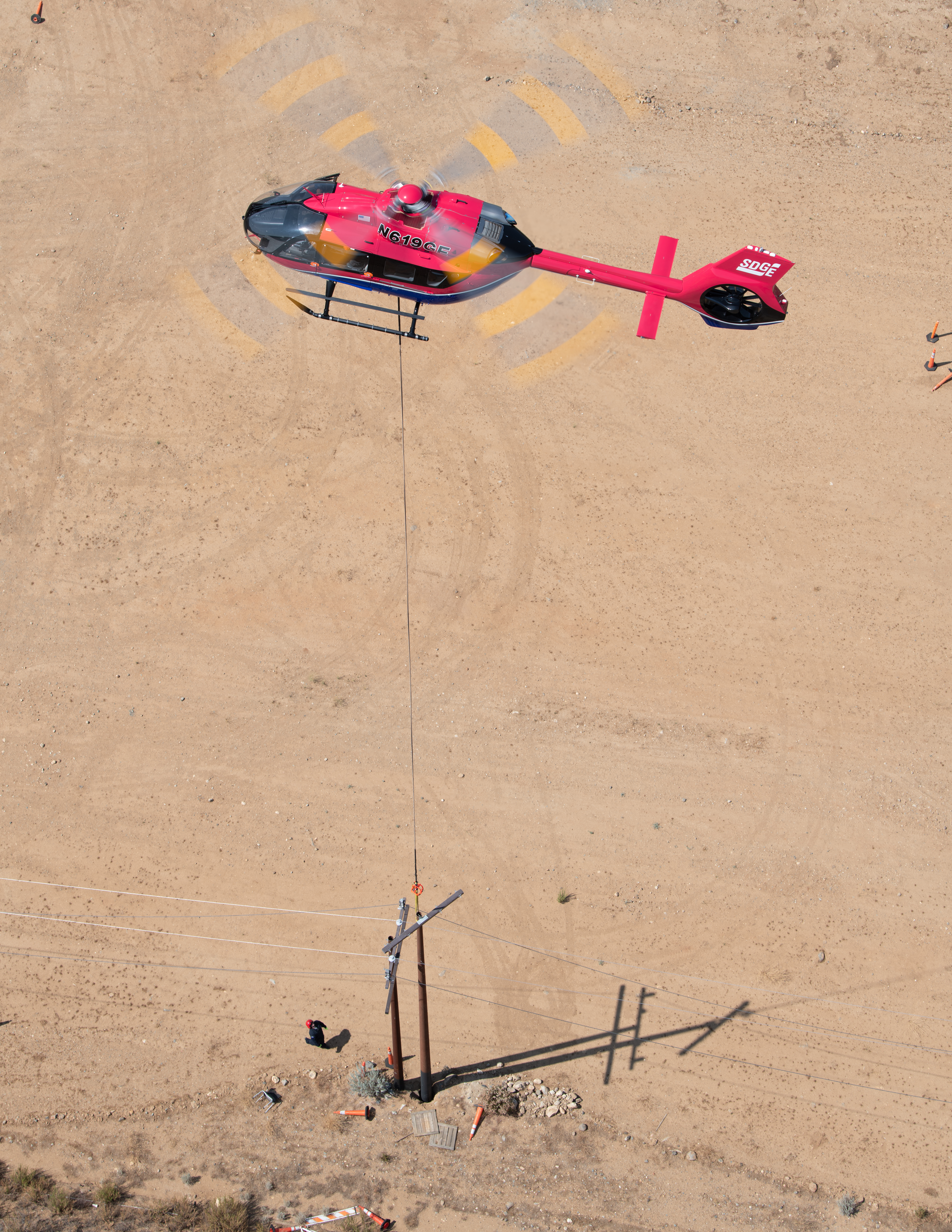 A helicopter placing a power pole